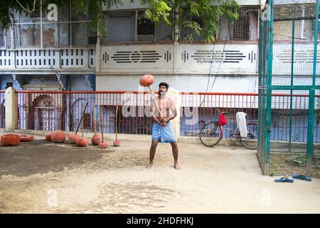 Nicht identifizierte indische Ringer trainieren, indem sie ihre traditionellen Ausrüstungen in der Nähe von ganga Ghat in Varanasi, Uttar Pradesh, Indien, anheben. Stockfoto