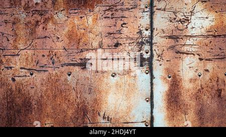 Rostiger Metallhintergrund, Kratzer Flecken Nieten und Nähte auf strukturiertem Eisen Wand Stockfoto