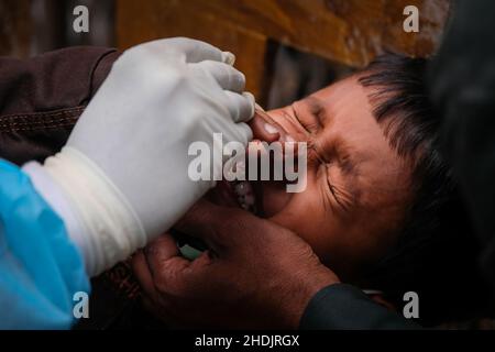 Kalkutta, Indien. 06th Januar 2022. Ein Kind reagiert, als ein Gesundheitsmitarbeiter im Madhyamgram Rural Hospital, Kalkutta, eine Abstrichprobe für RT-PCR-Tests für COVID-19 sammelt.Indien steht vor einer massiven Erhöhung der Covid-19-Fälle, berichtet über 90000 Fälle und 325 Todesfälle in den letzten 24 Stunden, Laut indischen Medienberichten wurde ein starker Anstieg von über 56 % verzeichnet. Govt aus Indien hat den Impfprozess sowie RT-PCR-Tests zur Kontrolle der Ausbreitung des Virus hochgefahren. Kredit: SOPA Images Limited/Alamy Live Nachrichten Stockfoto