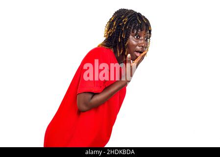 Schöne junge Frau überrascht und bedeckt den Mund mit der Hand innen. Stockfoto