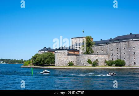 Schnellboote fahren an einem Sommertag an der Festung Vaxholm im Stockholmer Archipel vorbei Stockfoto