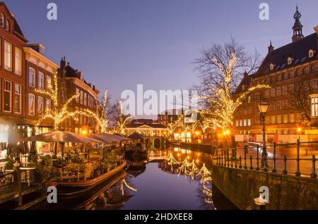 Leiden, Niederlande, 16. Dezember 2021: Blick entlang des Nieuwe Rijn (Neuer Rhein) Kanals während der blauen Stunde an einem windstillen Winterabend Stockfoto