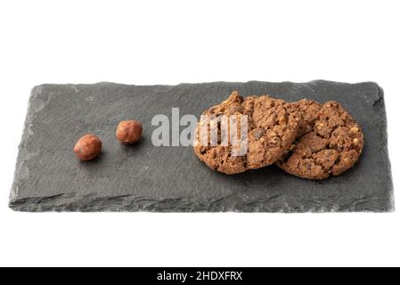 Haferflocken Müsli Cookies mit Haselnüssen gesunde Lebensmittel, auf einem Steinbrett zum Servieren. Gesunde Lebensweise Ernährung. Stockfoto