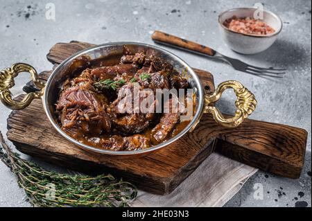 Deutsch geschmorte Rinderbacken in brauner Rotweinsauce. Grauer Hintergrund. Draufsicht Stockfoto