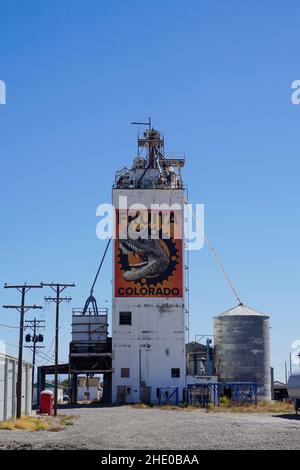 Fruita CO-OP-Düngergebäude mit einem großen Gemälde eines Dinosauriers an der Seite. Stockfoto