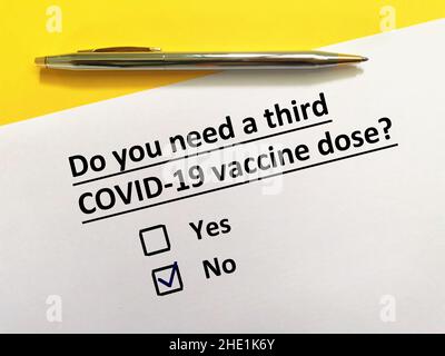 Eine Person beantwortet Fragen zu Impfstoffen. Die Person benötigt eine dritte COVID-19-Impfdosis. Stockfoto