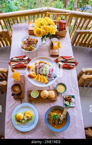 Blick von oben auf ein luxuriöses Frühstück in den Bergen von Chiang Mai Thailand, Luxus-Frühstück mit Chiang Mai-Nudelsuppe oder Khao Soi Gai und Obst und Kaffee auf dem Tisch Stockfoto