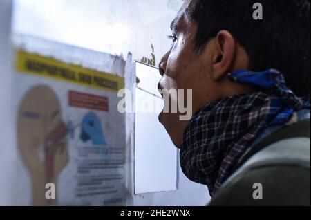 Guwahati, Indien. 08th Januar 2022. Ein Mitarbeiter des Gesundheitswesens nimmt am Samstag, den 8. Januar, im Bahnhof Guwahati in Guwahati, Assam, Indien, eine Abstrichprobe für COVID-19-Tests ab. 2022. Die täglichen Fälle von Covid-19 stiegen innerhalb von 24 Stunden um 21%, da Indien mehr als hunderttausend frische Infektionen verzeichnete. Quelle: David Talukdar/Alamy Live News Stockfoto