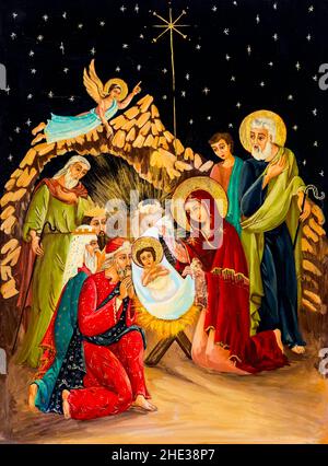 Naive Malerei, die die Geburt Jesu Christi auf Holztäfelchen darstellt. Weihnachtsgemälde mit Weihnachtskrippe. Stockfoto