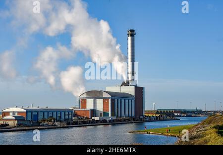 Brighton UK 9th January 2022 - Spaziergänger kommen an einem schönen sonnigen, aber kalten Tag an der Südküste am Gaskraftwerk Shoreham in der Nähe von Brighton vorbei : Credit Simon Dack / Alamy Live News Stockfoto