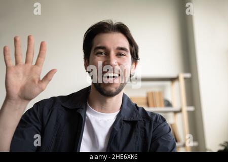 Glücklicher, gutaussehender junger Mann, der Videoanruf hält. Stockfoto