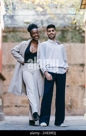 Zwei Modelle unterschiedlicher Ethnien posieren auf der Straße Stockfoto