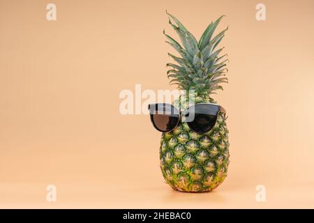 Interpretation der Ananasfrucht im menschlichen Bild im Sonnenbrillen Tourismus- und Urlaubskonzept. Platz auf gelbem Hintergrund kopieren Stockfoto