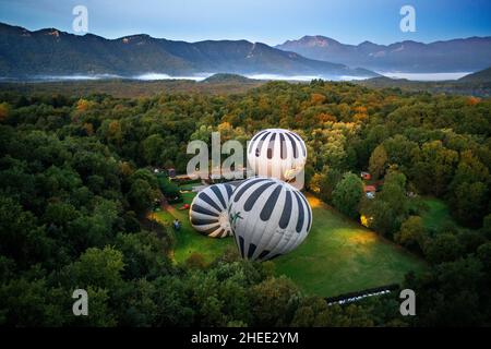 Heißluftballon, der La Fageda d' en Jordà und das vulkanische Gebiet von Olot, den Naturpark der vulkanischen Zone von La Garrotxa und die Berge auf dem fliegt Stockfoto