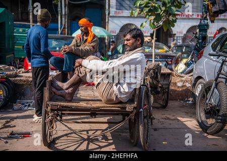 Neu-Delhi, Indien. 10th Januar 2022. Ein Arbeiter, der sich während seiner Arbeitszeit auf seiner Dreirad-Rikscha ausruht. Weniger Arbeit auf dem Markt aufgrund von Covid19, auf Chandni Chowk Market, Geschäfte dürfen nur auf ungerader Basis öffnen (ungerade-gerade Regelung ist ein Rationierungssystem) zwischen 10 und 8 Uhr inmitten der dritten Welle von Coronavirus in Delhi. (Foto von Pradeep Gaur/SOPA Images/Sipa USA) Quelle: SIPA USA/Alamy Live News Stockfoto