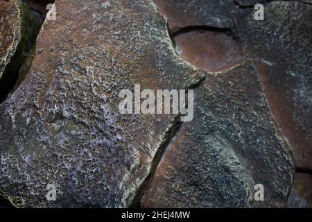 Die Textur des Steins ist braun mit großen Rissen Stockfoto