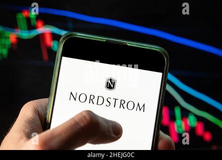 China. 4th Dez 2021. Auf dieser Fototafel ist das Logo der amerikanischen Kette des Luxusschmuckkaufhauses Nordstrom zu sehen, das auf einem Smartphone mit einem Index der wirtschaftlichen Börse im Hintergrund dargestellt ist. (Bild: © Budrul Chukrut/SOPA Images via ZUMA Press Wire) Stockfoto