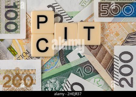 Die Formulierung „PIT“ und „CIT“ wurde mit „Personal Income Tax“ und „Company Income Tax“ sowie vielen polnischen Banknoten übersetzt. Neue Steuervorschriften in Polen ab 2022. Stockfoto
