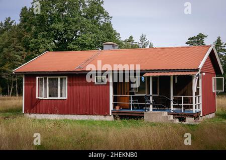 Symbolisches Bild: Kleines Holzhaus im Stil einer typisch schwedischen Holzhütte. Stockfoto