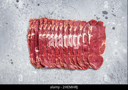 Türkisches Pastrami-Rindfleisch mit Speck. Grauer Hintergrund. Draufsicht Stockfoto