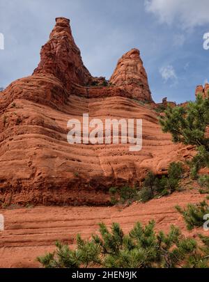 Streaker Spire (links), Christianity Spire und The White Line, Sedona, Arizona. Die Weiße Linie, auf halber Höhe der Felswand, ist eine beliebte Herausforderung für Mo Stockfoto