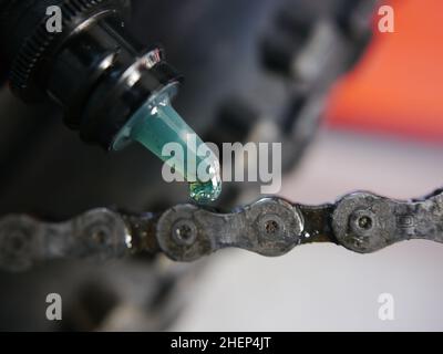 Senior Mann Hände sprühen ein Fahrrad, tun Wartung Stockfoto