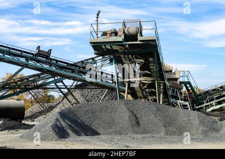 Mobile Steinbrecher-Maschine auf der Baustelle oder im Bergbau zum Zerkleinern alter Betonplatten zu Kies und anschließender Zementproduktion. Stockfoto