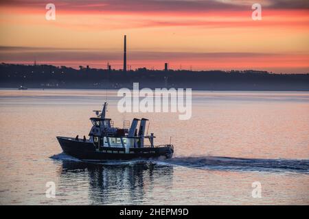 Cobh, Cork, Irland. 12th. Januar 2022. Ferry Kaycraft transportiert Marinepersonal vor Sonnenaufgang zwischen dem Marinestützpunkt an der Haulbowline und dem Marinepier in Cobh, Co. Cork, Irland.- Credit; David Creedon / Alamy Live News Stockfoto