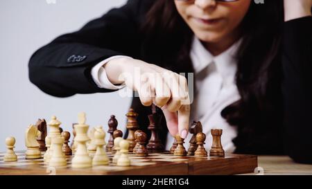 Beschnittene Ansicht einer Geschäftsfrau, die Schach spielt, isoliert auf weißem Stockbild Stockfoto