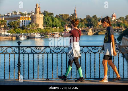 Touristen im Guadalquivir-Fluss und dem Torre del Oro, was sich mit dem Turm des Goldes übersetzt - historisches Wahrzeichen aus dem XIII. Jahrhundert in Sevilla, Andalusien, S Stockfoto