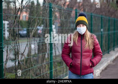 Kranke Frau mit chirurgischer Gesichtsmaske auf der Straße der Stadt. Frau im Gesichtsmast, um die Ausbreitung von Grippe oder Coronavirus zu verhindern. Stockfoto