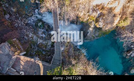 Luftaufnahme von Touristen, die auf einer Holzbrücke am Sum-Wasserfall in der Vintgar-Schlucht neben Bled, Slowenien, stehen Stockfoto