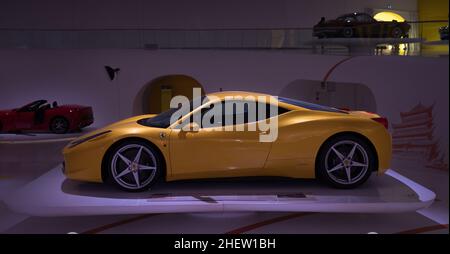 Modena, Italien - 14. Juli 2021: Gelber Rennsport-Sportwagen des Modells Ferrari 458 in einem dunklen Hangar im Museo Casa Enzo Ferrari, Italien. Stockfoto