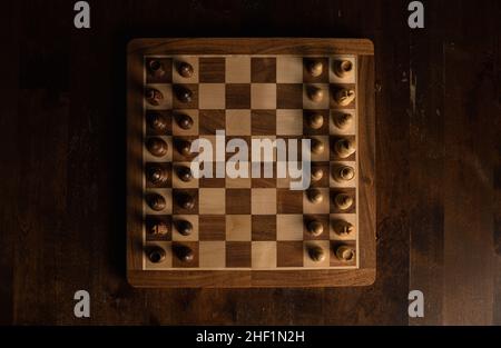 Holzschachbrett und Spielsteine Stockfoto