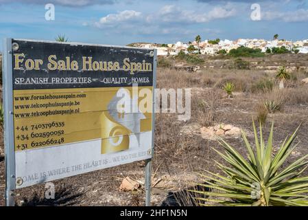 Verfallendes Immobilienmakler-Zeichen auf leerem Buschland in Camposol, Region de Murcia, Costa Calida, Spanien, EU. Eine Stadt, die bei britischen Ex-Pats beliebt ist. Hotelanzeige Stockfoto