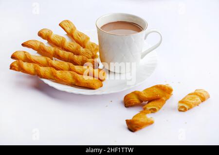 Indische khari oder Karee oder salzige Puffy braune Snacks, serviert mit indischem heißen Tee, indisches Frühstück. Stockfoto