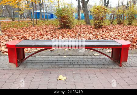 Leere Holzbank im Herbstpark Stockfoto