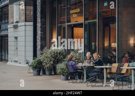 London, Großbritannien - 02. Januar 2022: Menschen an den Tischen im Freien des Granger and Co Aussie-inspirierten Restaurants am Pancras Square, einem Platz im kontinentalen Stil Stockfoto