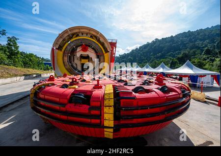 (220113) -- BENTONG (MALAYSIA), 13. Januar 2022 (Xinhua) -- die massive, in China hergestellte Tunnelbohrmaschine (TBM) wird am 13. Januar 2022 eingesetzt, um die Aushubarbeiten für den Genting-Tunnel der Eisenbahnverbindung an der Ostküste in der Nähe von Bentong im malaysischen Bundesstaat Pahang anzuführen. Der East Coast Rail Link (ECRL), Malaysias Mega-Eisenbahnprojekt, das von der China Communications Construction Company (CCCC) gebaut wird, profitiert stark von der soliden Erfahrung und dem technischen Know-how des chinesischen Unternehmens, sagte der malaysische Verkehrsminister Wee Ka Siong am Donnerstag. Die ECRL läuft von Malaysias größtem Verkehrsknotenpunkt Port ULA aus Stockfoto