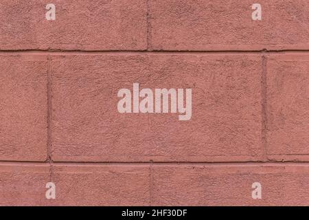 Ein Teil der Fassade des Hauses mit gemalten Wand aus Ziegelsteinen mit brauner Farbe außen Architektur Hintergrund. Stockfoto