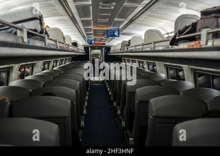 Boston, USA - 22. Oktober 2021: Leeres Interieur des Amtrak-Zuges mit Sitzreihen. In einem dunklen Zug während einer Pandemie Stockfoto