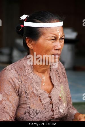 Die balinesische Frau bereitet sich auf eine Zeremonie vor, die im Dorf Ketewel in Gianyar, Bali, Indonesien, stattfindet Stockfoto