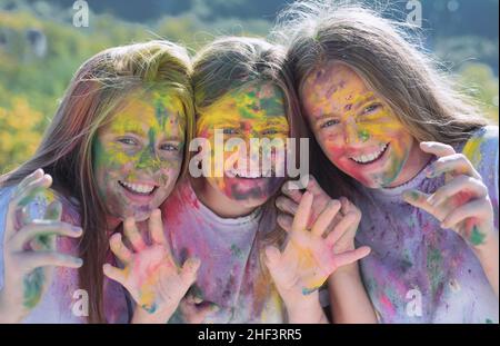 Teenager Freunde mit trockenen Farben. Drycolors. Teenager-Schule Freunde mit Spaß Huckepack im Freien mit trockenen Farben. Fröhliche Stimmung mit bunten Stockfoto