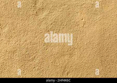 Ockerfarbener Wandhintergrund gibt ein harmonisches Muster Stockfoto