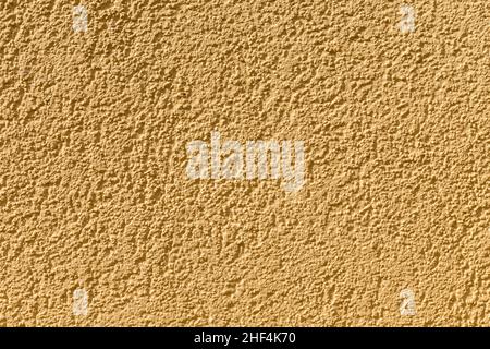 Ockerfarbener Wandhintergrund gibt ein harmonisches Muster Stockfoto