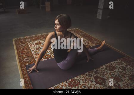 Yogi Frauen üben Yoga Pose auf Matte im Vintage Wohnzimmer, Paripurna Navasana Übung, Sport Workout Style, Fitness zu Hause, Gesunder Lebensstil. Nahaufnahme. Hochwertige Fotos Stockfoto