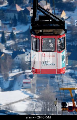 Oberwiesenthal, Deutschland. 14th Januar 2022. Eine Gondelbahn senkt den Fichtelberg. Nach der koronabedingten Pause öffnet das Skigebiet in Sachsen unter hygienischen Bedingungen. Quelle: Sebastian Willnow/dpa-Zentralbild/dpa/Alamy Live News Stockfoto