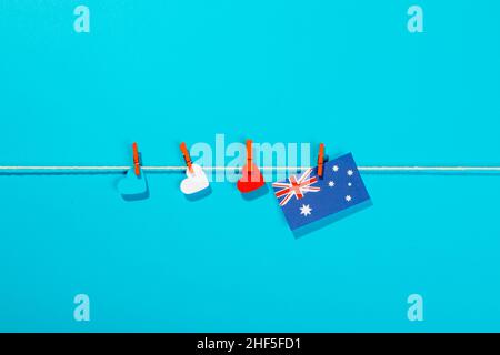Australien Flagge und herzförmige Papiere auf Wäscheleine isoliert auf blauem Hintergrund mit Kopierraum Stockfoto