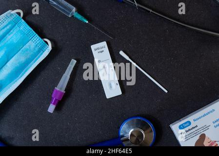Ein schneller Antigen-Test auf SARS-CoV-2 oder Covid wird auf einem Tisch mit Nasenstäbchen während eines schnellen Bedarfs aufgrund der Omicron-Variante von Cov gesehen Stockfoto
