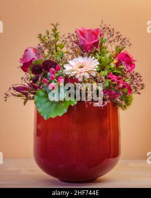 Nahaufnahme eines Blumenstraußes in einer roten Vase Stockfoto